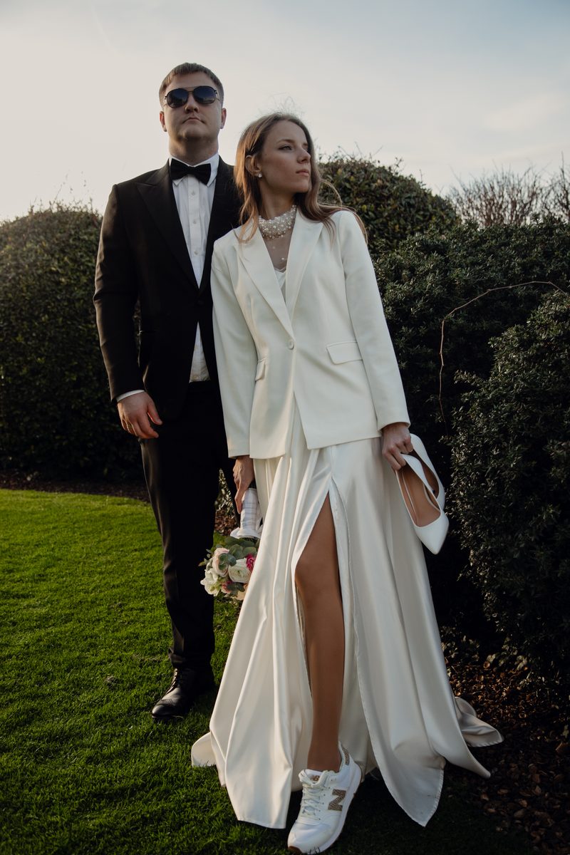Wedding couple walking through a garden in soft afternoon light